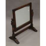 A carved oak dressing table mirror. 53 cm wide.