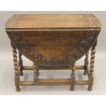 A Victorian carved oak gate leg table. 90 cm long.