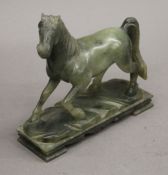 A carved jade model of a horse. 15.5 cm wide.