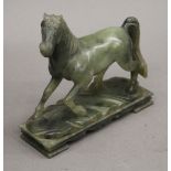 A carved jade model of a horse. 15.5 cm wide.