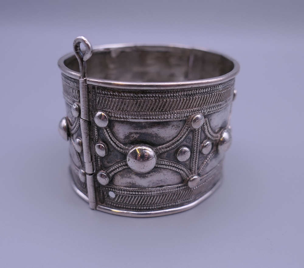 Three Eastern white metal bangles, two probably unmarked silver. The largest 12.5 cm diameter. - Image 4 of 14