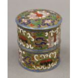 A Chinese enamel decorated two section lidded box. 7 cm high.