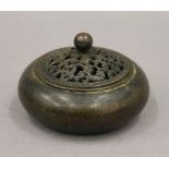 A Chinese bronze lidded censer. 10 cm diameter.