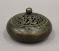 A Chinese bronze lidded censer. 10 cm diameter.