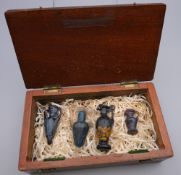 Two Roman style miniature glass amphora and two miniature glass ewers, in mahogany box.