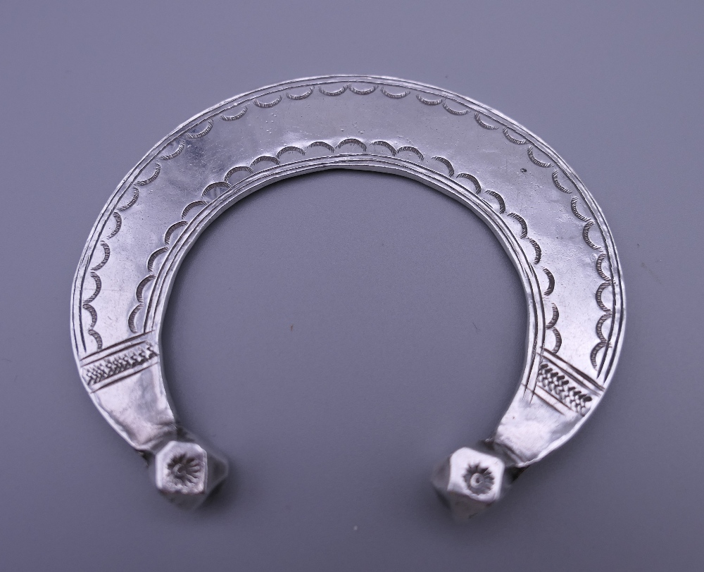 Three Eastern white metal bangles, two probably unmarked silver. The largest 12.5 cm diameter. - Image 3 of 14