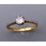 An 18 ct gold diamond solitaire ring. Ring size I/J. 1.7 grammes total weight.