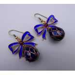 A pair of enamel decorated egg form earrings. 3 cm high.