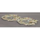 A pair of Continental porcelain florally encrusted and figural wall mirrors. 46 cm high.
