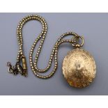 A Victorian unmarked gold locket (17 grammes total weight) on an associated plated chain.