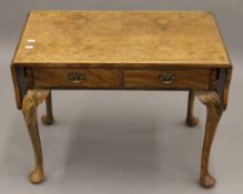 A walnut drop flap coffee table. 72 cm wide flaps down.