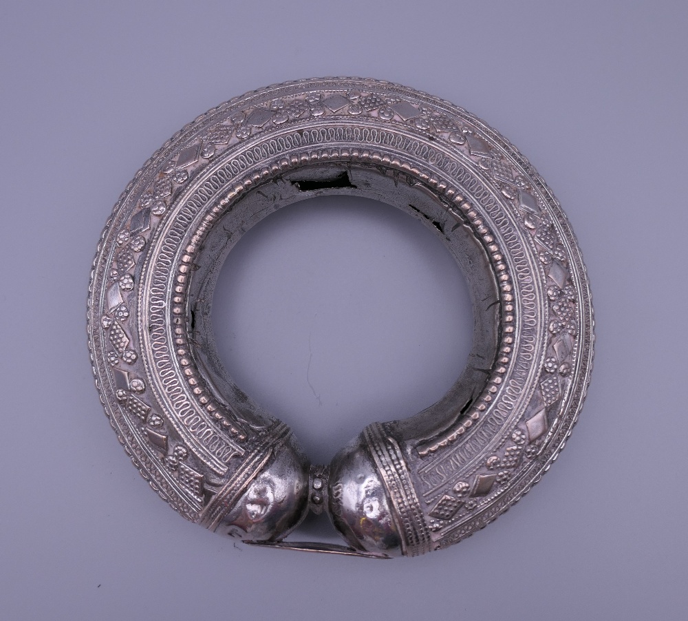 Three Eastern white metal bangles, two probably unmarked silver. The largest 12.5 cm diameter. - Image 7 of 14