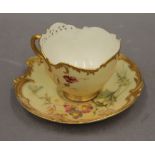 A Royal Worcester blush ivory cup and saucer. The cup 10 cm wide.