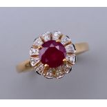 A 9 ct gold, ruby and diamond ring. Ring size L/M. 3.1 grammes total weight.