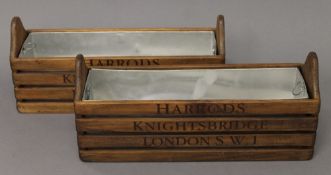 A pair of wooden troughs inscribed Harrods. 35 cm long.