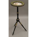 A Victorian ebonised side table with porcelain inset top. 77.5 cm high.