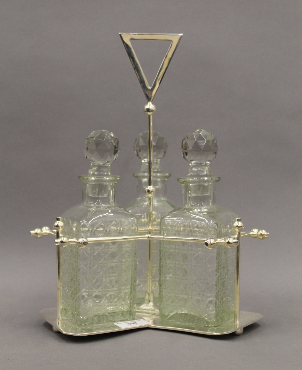A silver plated three bottle decanter stand. 34 cm high. - Image 2 of 2