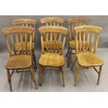 A set of six Victorian elm seated splat back kitchen chairs. 37 cm wide.