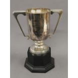 An engraved silver trophy cup on stand. 33.5 cm high overall. 30.2 troy ounces total weight.