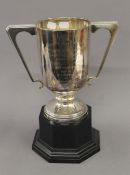An engraved silver trophy cup on stand. 33.5 cm high overall. 30.2 troy ounces total weight.