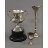 A silver bud vase, a small silver trophy cup and a broken silver trophy cup. The former 22 cm high.