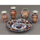 Five 19th century Japanese Imari porcelain items; comprising of an oval platter and four vases.