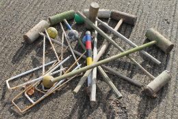 A quantity of vintage croquet equipment.