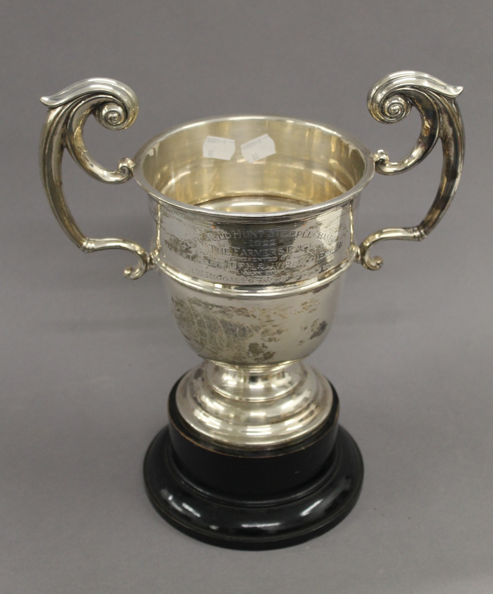 An engraved silver trophy cup on stand. 33.5 cm high overall. 25.1 troy ounces.