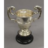 An engraved silver trophy cup on stand. 33.5 cm high overall. 25.1 troy ounces.