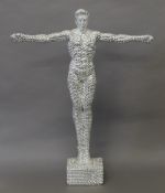 A silver coloured model of a gymnast. 58 cm high.