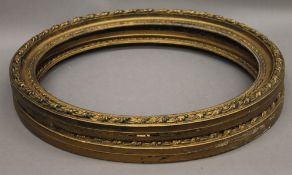 A pair of gilt oval frames. 58 x 48.5 cm.