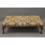 An early 20th century upholstered stool. 124 cm long.