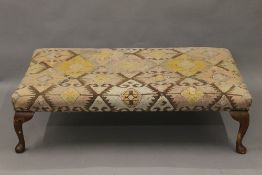 An early 20th century upholstered stool. 124 cm long.