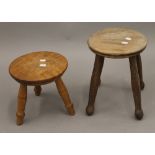 A late 19th/early 20th century elm seated stool and two others. The former 31 cm high.