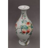 A Chinese peach decorated porcelain vase. 35 cm high.