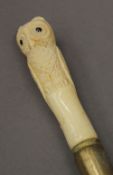 A walking stick with owl form bone handle. 90 cm high.