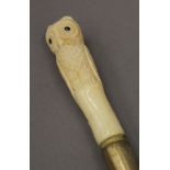 A walking stick with owl form bone handle. 90 cm high.