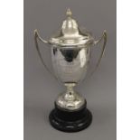 An engraved lidded silver trophy cup on stand. 37.5 cm high overall. 20.4 troy ounces.