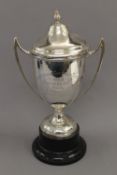 An engraved lidded silver trophy cup on stand. 37.5 cm high overall. 20.4 troy ounces.
