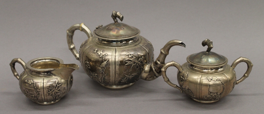 A Chinese silver three-piece tea set. The teapot 25 cm long. 30.1 troy ounces.