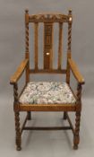 An early 20th century oak barley twist open armchair. 56 cm wide.