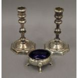 A Georgian silver salt and a pair of plated candlesticks. The former 8 cm wide.