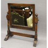 A carved oak dressing table mirror. 57 cm wide.