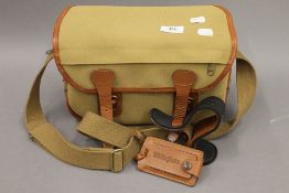 A Billingham camera and lens shoulder bag. 30 cm wide.