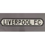 A 'Liverpool FC' wooden sign.