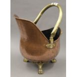 An early 20th century Arts and Crafts style copper and brass coal scuttle. 60 cm high.