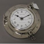 A chrome Neptune port hole style clock. 24 cm diameter.