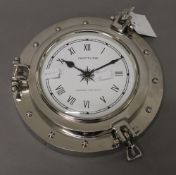 A chrome Neptune port hole style clock. 24 cm diameter.