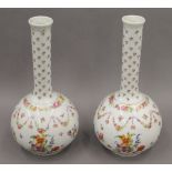 A pair of late 19th century florally decorated Continental porcelain vases. Each 31.5 cm high.