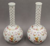 A pair of late 19th century florally decorated Continental porcelain vases. Each 31.5 cm high.